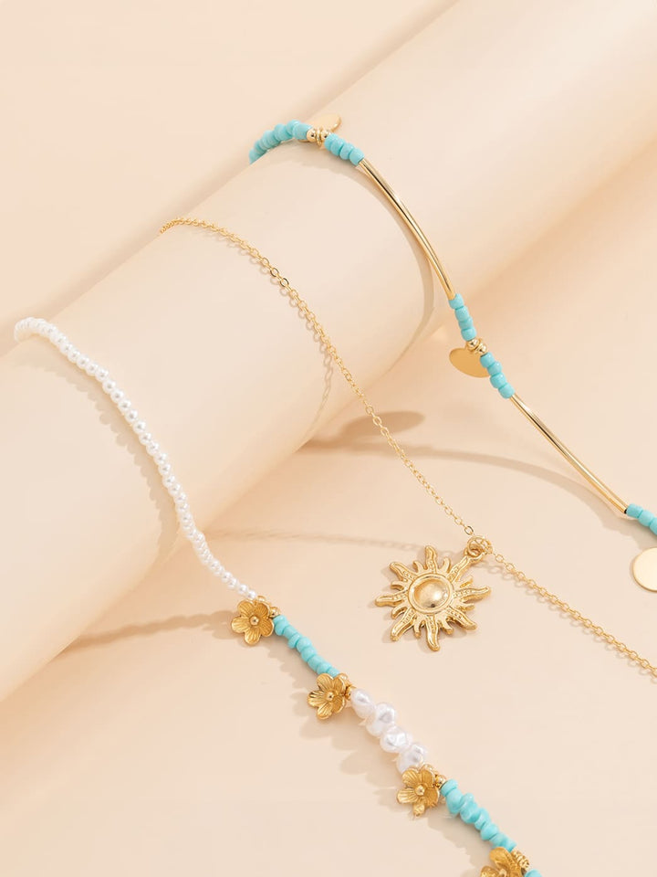 3-teilige Halskette mit Kunstperlen und Sonnen- und Blumenmuster